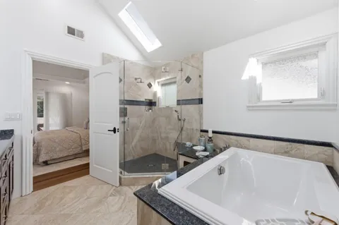 a bathroom with a tub sink and shower