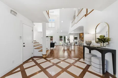 a view of dining room and livingroom with furniture wooden floor and a rug