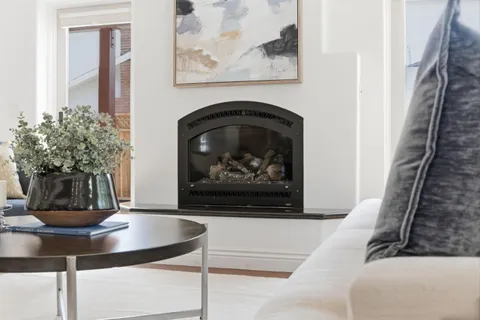 a living room with furniture and a fireplace