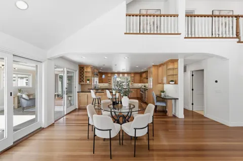 a dining room with furniture and wooden floor