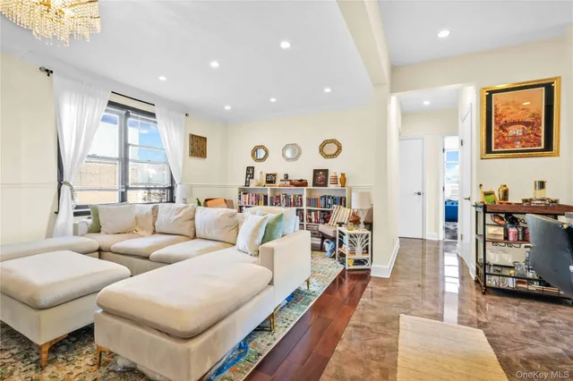 a living room with furniture a rug and a large window