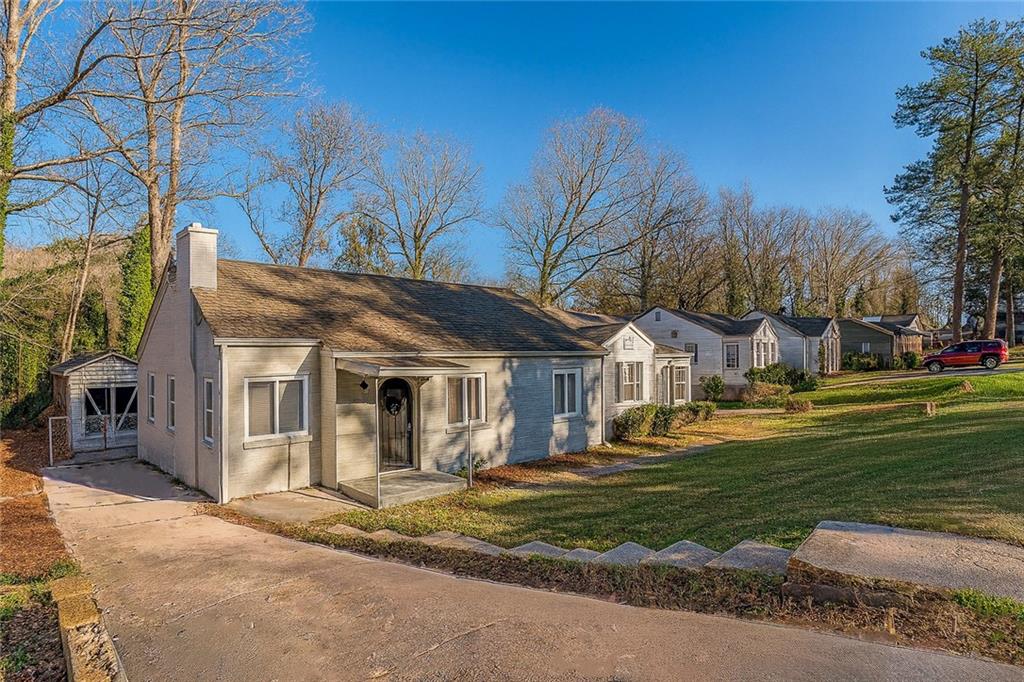 a front view of a house with a garden