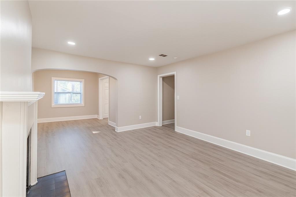 1376 Westmont Road Southwest Atlanta, GA 30311 - Photo 11 of 41 an empty room with wooden floor and windows
