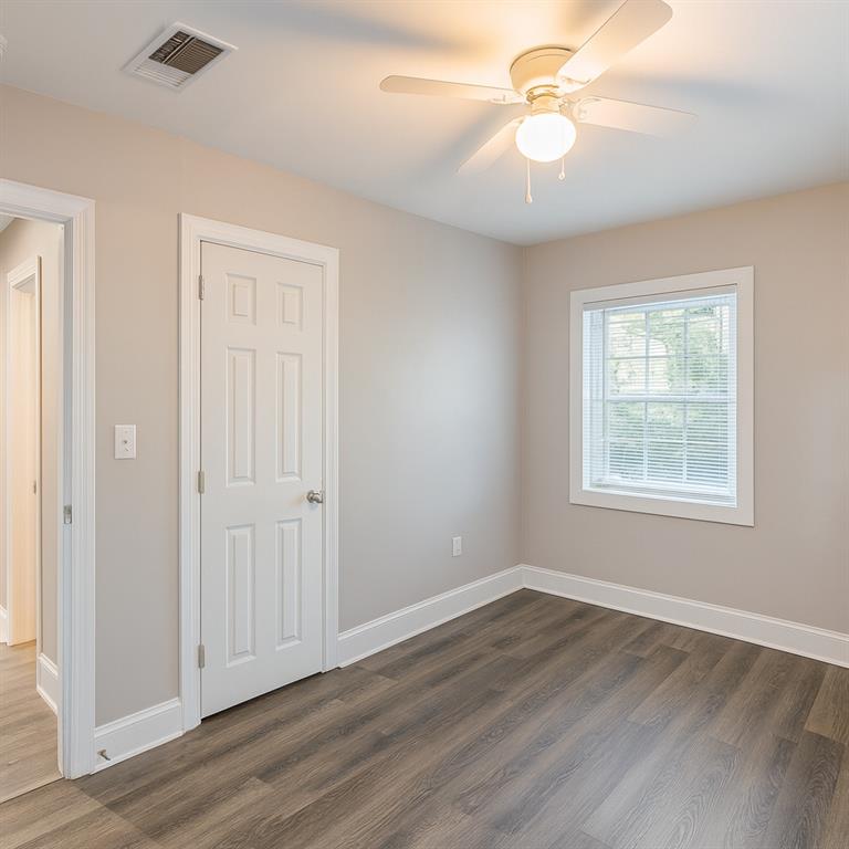 1376 Westmont Road Southwest Atlanta, GA 30311 - Photo 22 of 41 wooden floor in an empty room with a window