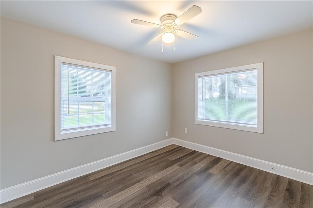 1376 Westmont Road Southwest Atlanta, GA 30311 - Photo 29 of 41 a view of an empty room with wooden floor and a window