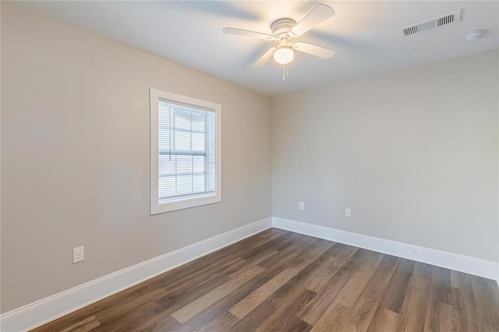 1376 Westmont Road Southwest Atlanta, GA 30311 - Photo 30 of 41 wooden floor in an empty room with a window
