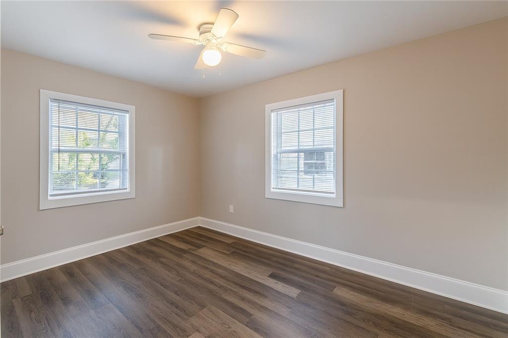 1376 Westmont Road Southwest Atlanta, GA 30311 - Photo 31 of 41 a view of empty room with wooden floor and fan