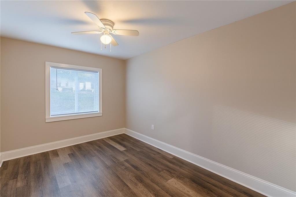 1376 Westmont Road Southwest Atlanta, GA 30311 - Photo 33 of 41 wooden floor in an empty room with a window