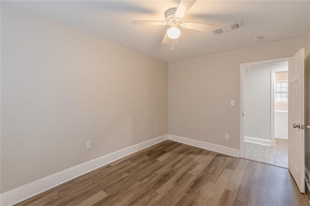 1376 Westmont Road Southwest Atlanta, GA 30311 - Photo 35 of 41 a view of a room with wooden floor and ceiling fan