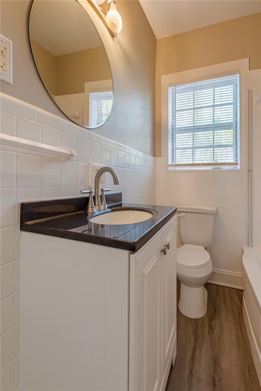 1376 Westmont Road Southwest Atlanta, GA 30311 - Photo 37 of 41 a bathroom with a toilet a sink and mirror