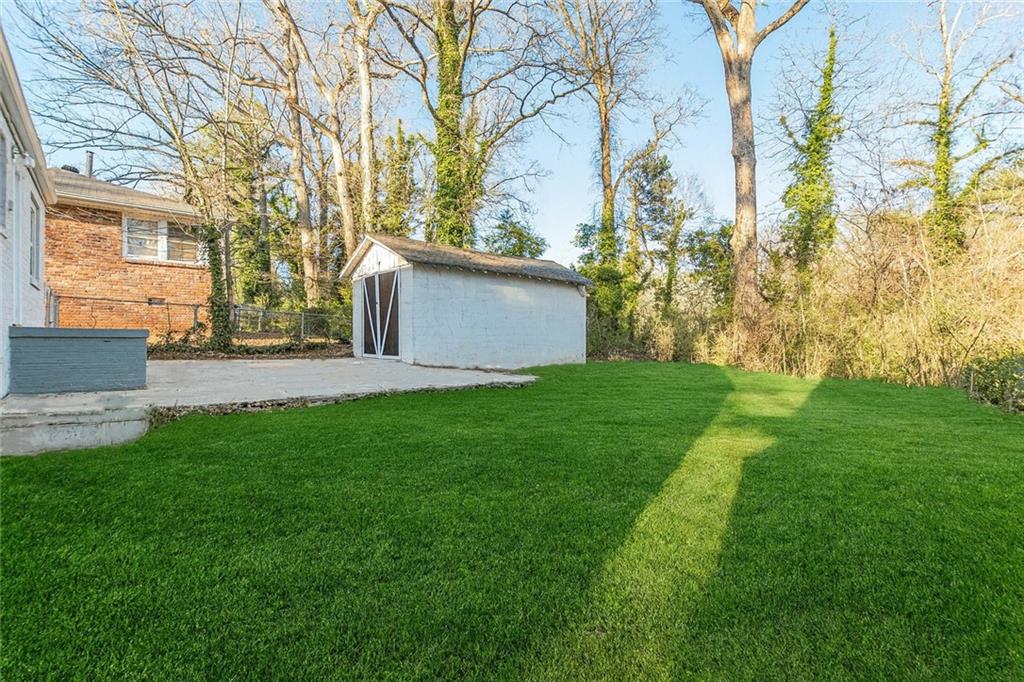 1376 Westmont Road Southwest Atlanta, GA 30311 - Photo 40 of 41 a view of a house with backyard and a tree