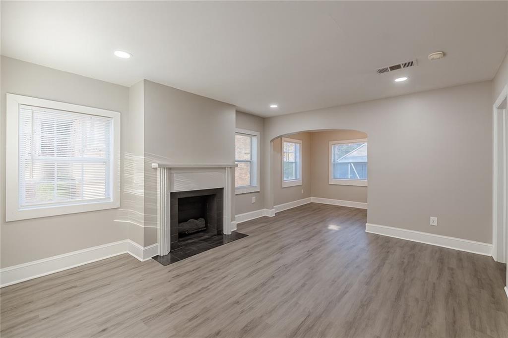 1376 Westmont Road Southwest Atlanta, GA 30311 - Photo 7 of 41 a view of an empty room with wooden floor and a window