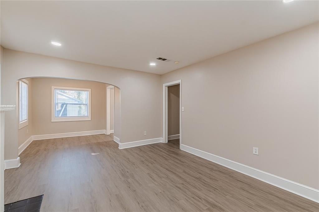 1376 Westmont Road Southwest Atlanta, GA 30311 - Photo 10 of 41 an empty room with wooden floor and windows