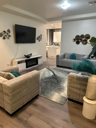 a living room with furniture and a flat screen tv