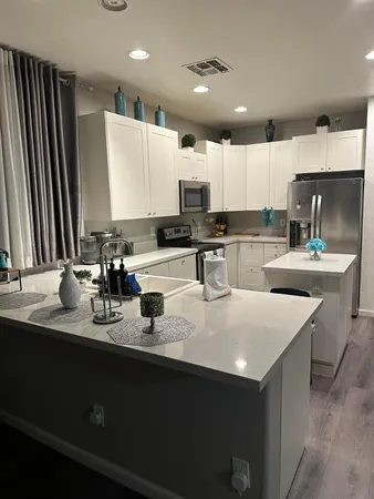 a kitchen with sink a stove and cabinets