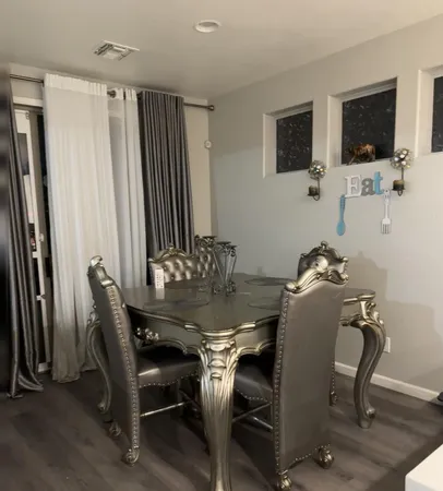 a view of a dining room with furniture and a flat screen tv