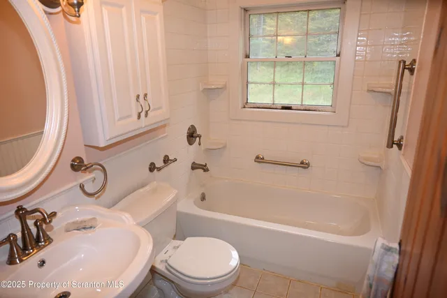 a bathroom with a sink a mirror and a vanity