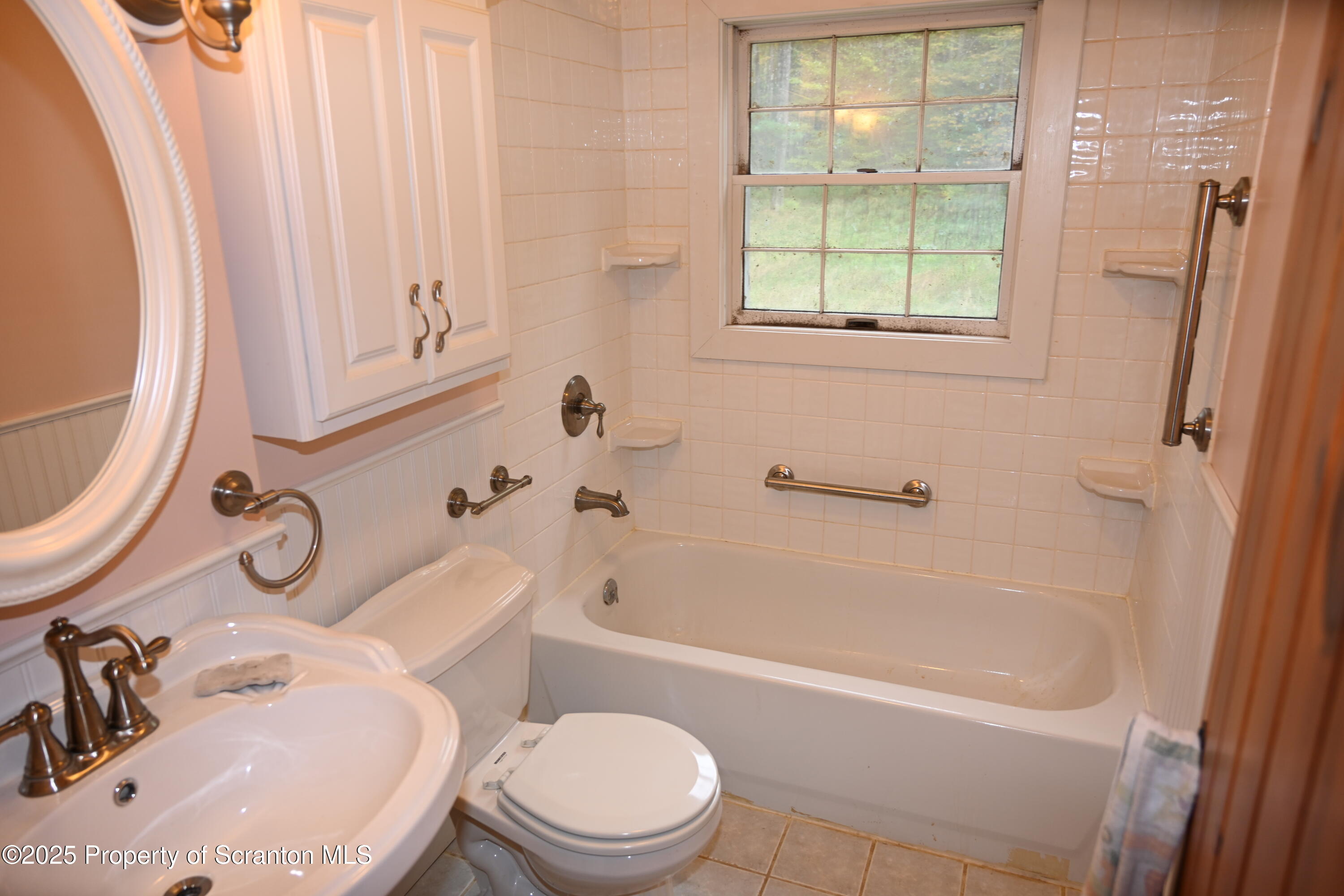 1271 Graham Holw Road Hallstead, PA 18822 - Photo 14 of 56 a bathroom with a sink a toilet and tub