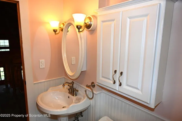 a view of a porch with wooden floor and a gate
