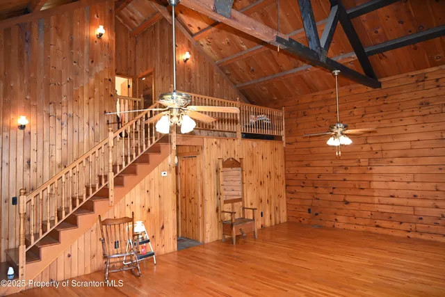 a view of a room with wooden floor and staircase