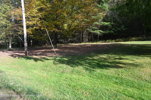 a view of a wooden house with a yard