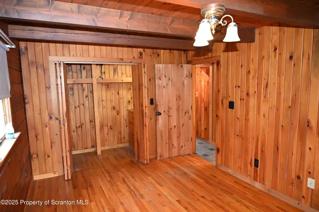 a view of a room with wooden floor