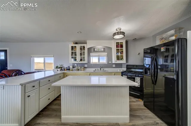 a kitchen with a sink a counter and a window