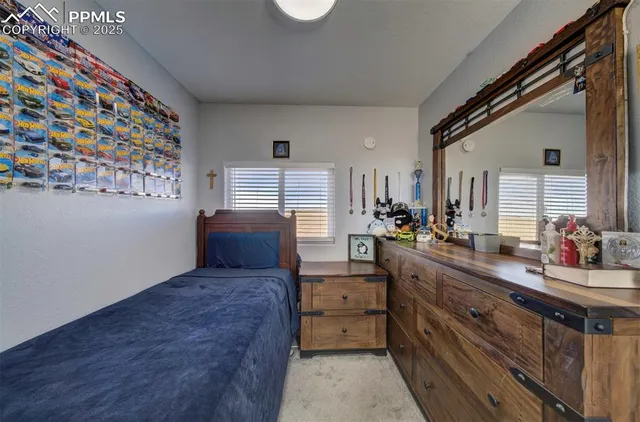 a bed sitting in a bedroom next to a window