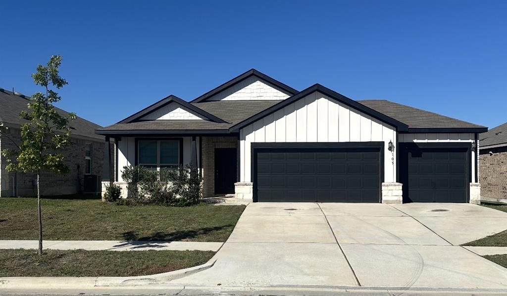 105 Onna Street Taylor, TX 76574 - Photo 1 of 1 a front view of a house with garden