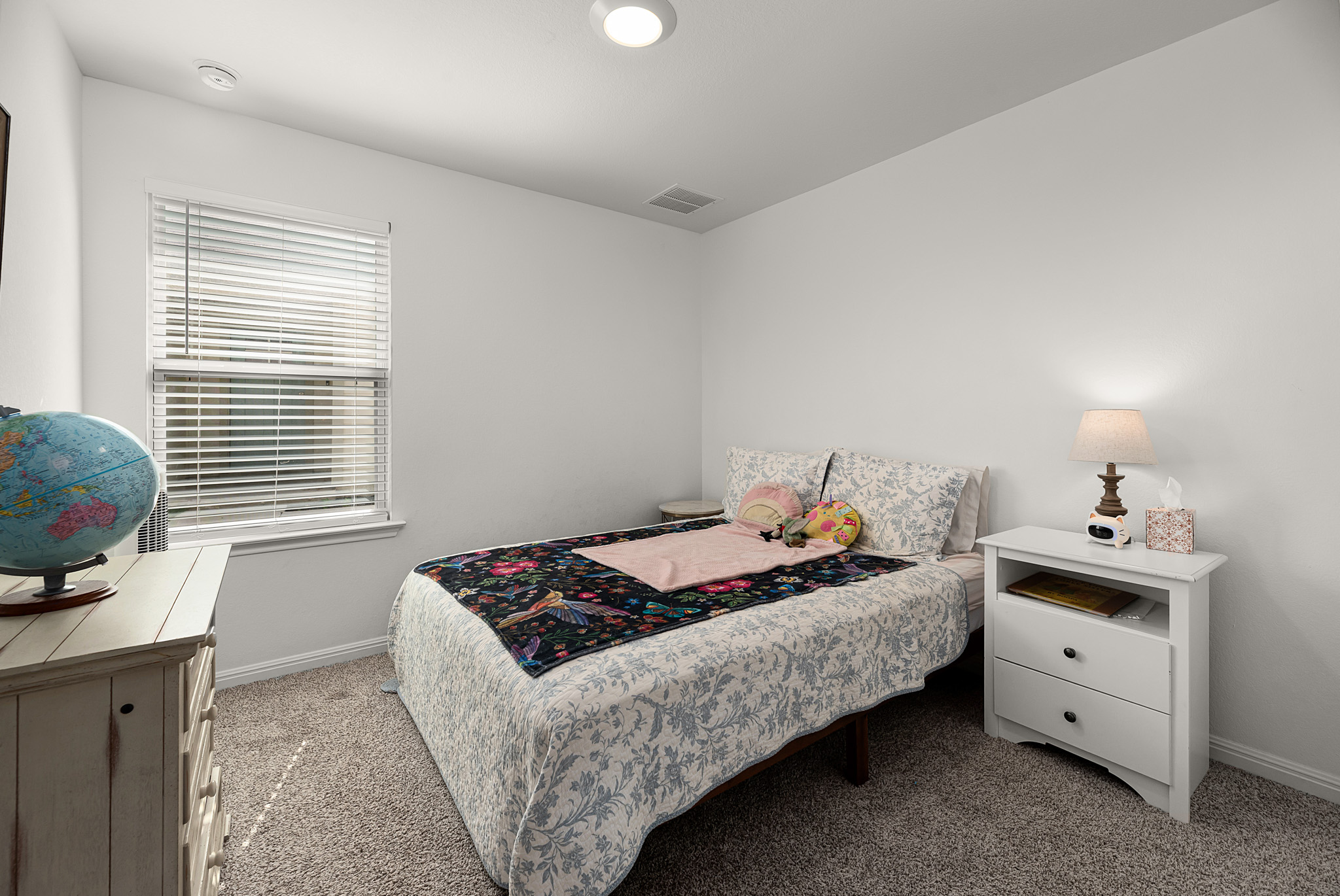 165 Santa Rosa Lane Buda, TX 78610 - Photo 14 of 21 a bedroom with a bed and a window