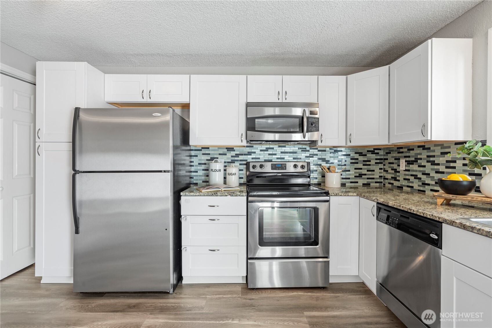 31921 46th Avenue Southwest Federal Way, WA 98023 - Photo 12 of 28 a kitchen with stainless steel appliances a refrigerator stove and microwave