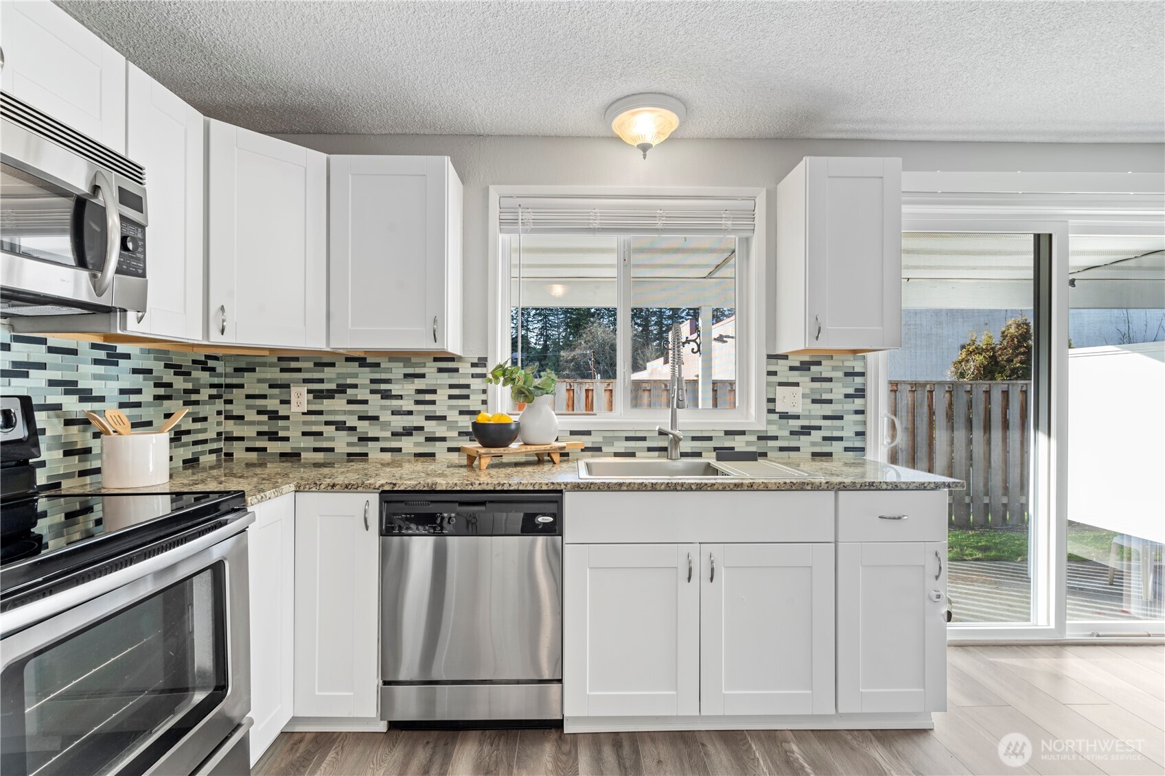 31921 46th Avenue Southwest Federal Way, WA 98023 - Photo 13 of 28 a kitchen with granite countertop a sink stainless steel appliances and cabinets