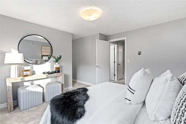 a room with a bed a mirror and a window