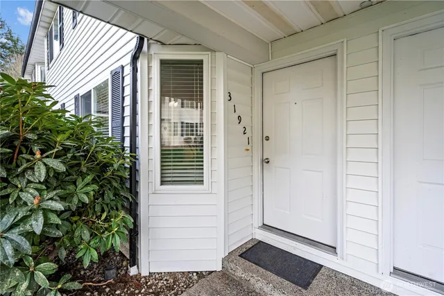 a view of a house with a door and wooden floor