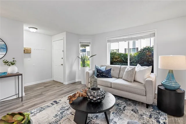 a living room with furniture and a potted plant