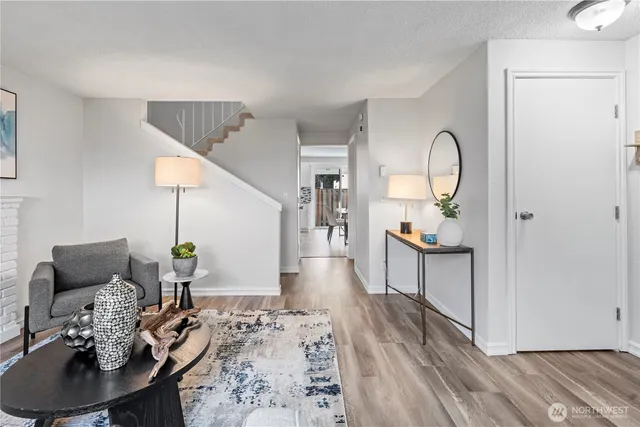 a living room with furniture and wooden floor