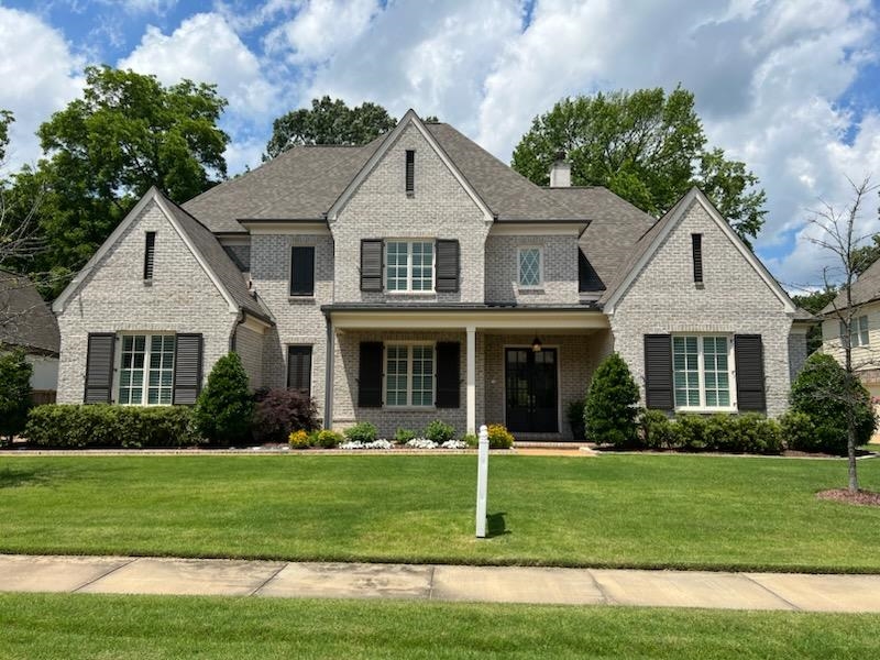 47 Addiegreen Cove Collierville, TN 38017 - Photo 1 of 34 a front view of a house with a garden