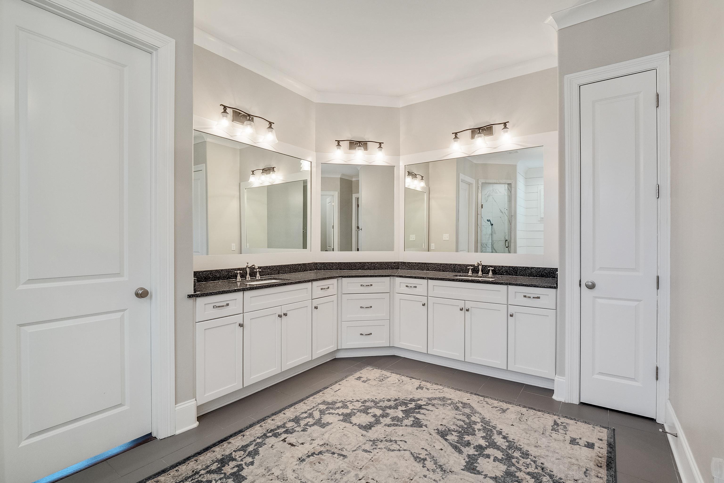 47 Addiegreen Cove Collierville, TN 38017 - Photo 13 of 34 a spacious bathroom with a granite countertop sink and a mirror