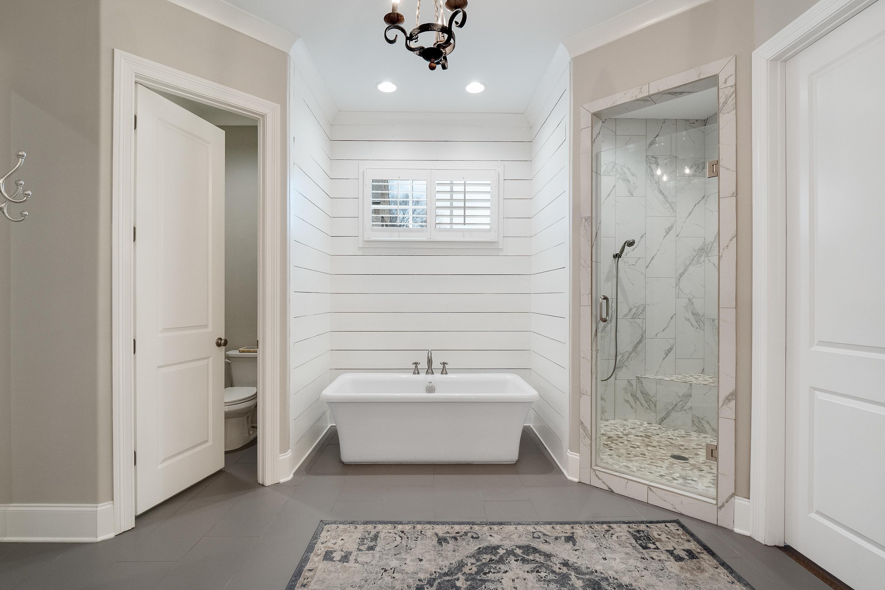 47 Addiegreen Cove Collierville, TN 38017 - Photo 14 of 34 a spacious bathroom with a bathtub a shower and a sink