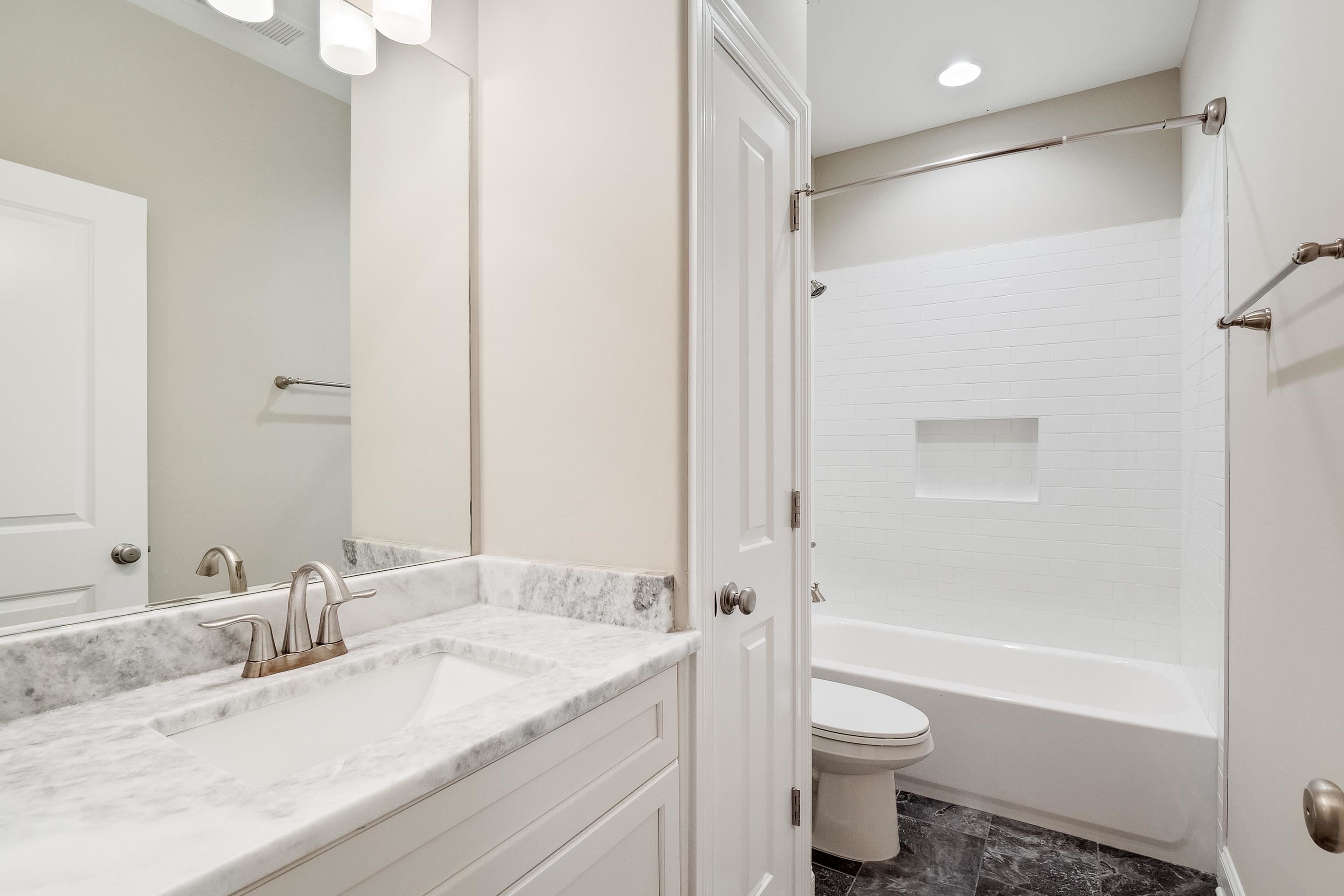 47 Addiegreen Cove Collierville, TN 38017 - Photo 19 of 34 a bathroom with a granite countertop sink toilet and shower