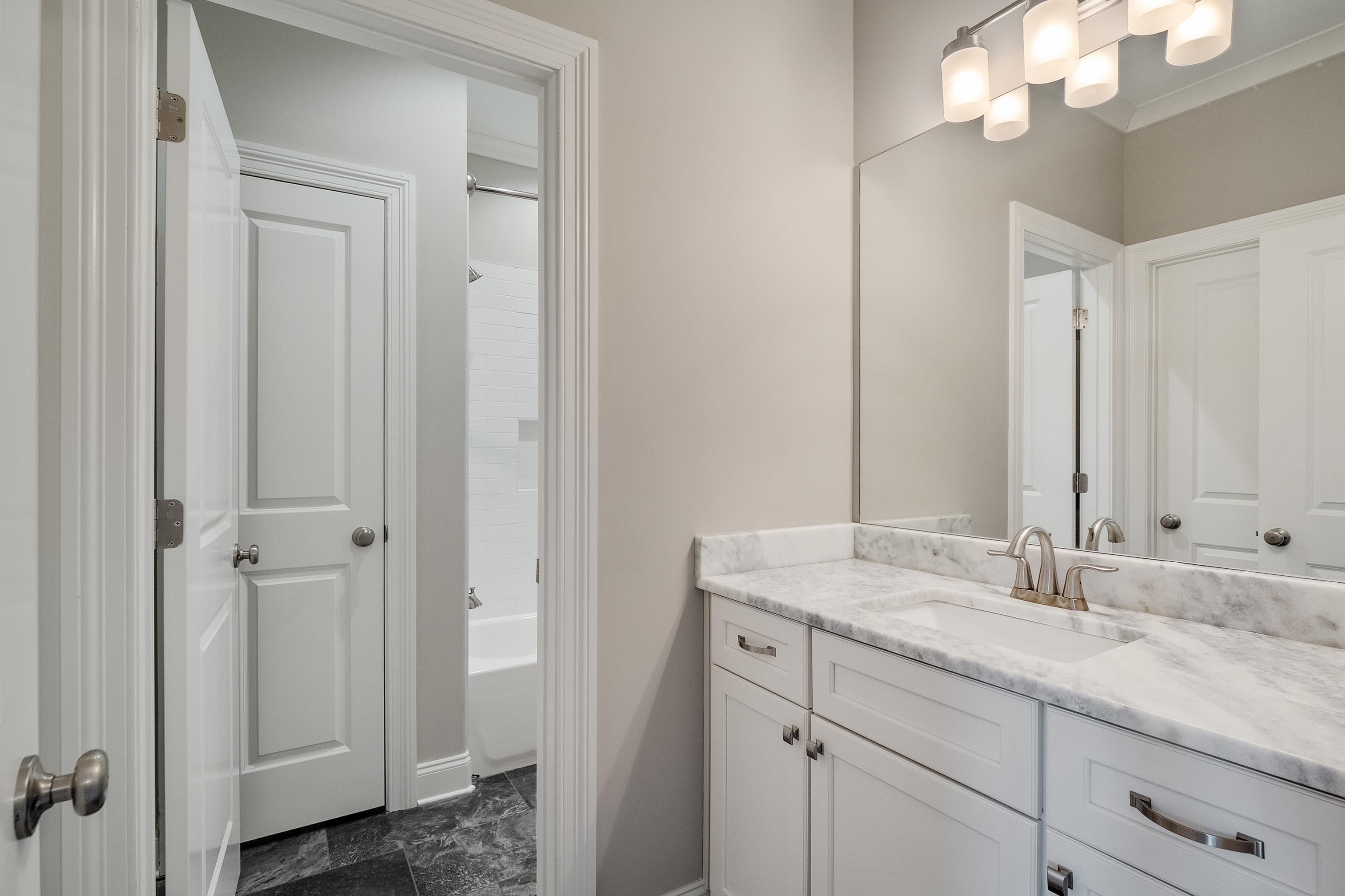 47 Addiegreen Cove Collierville, TN 38017 - Photo 24 of 34 a bathroom with a sink and a mirror