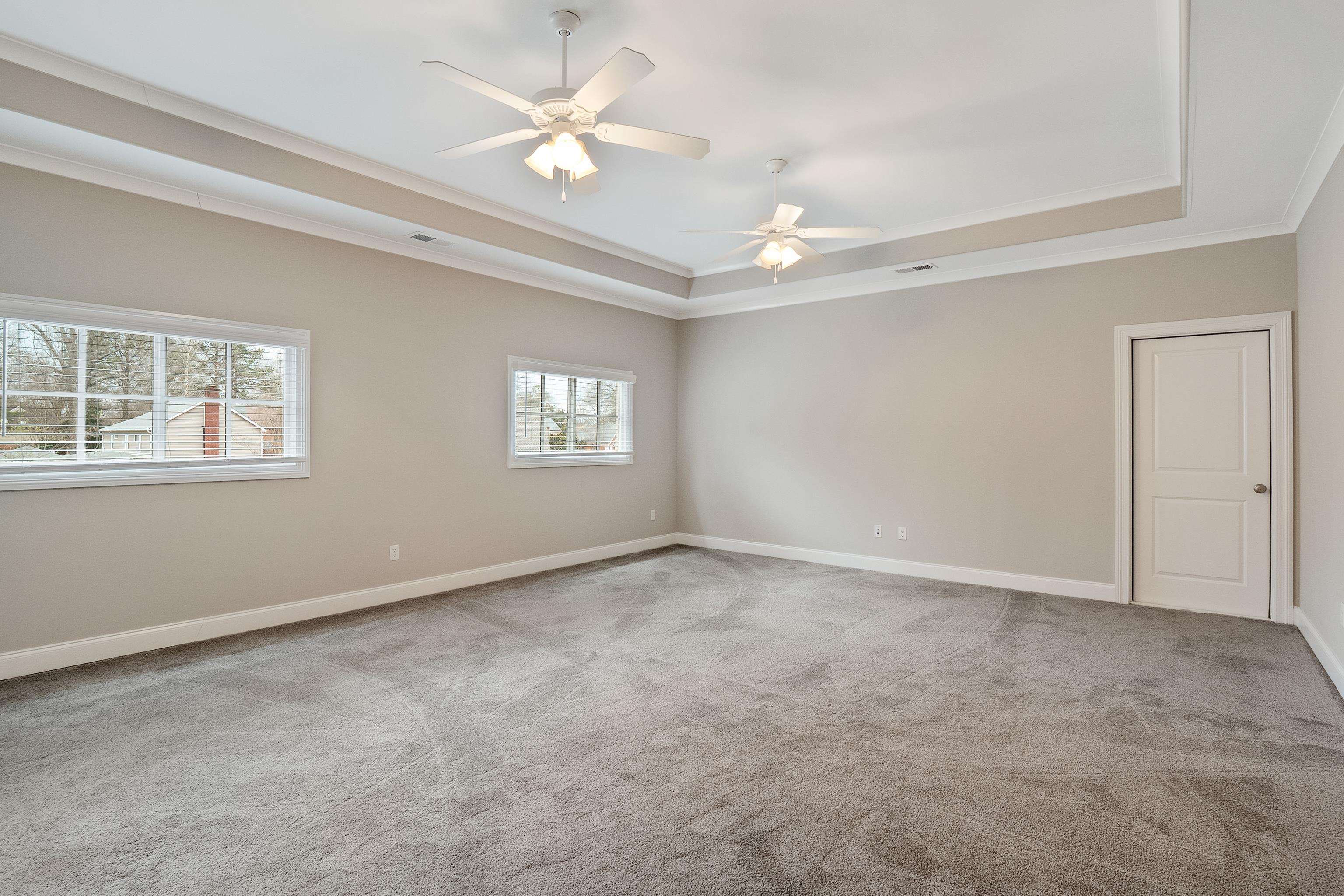 47 Addiegreen Cove Collierville, TN 38017 - Photo 26 of 34 an empty room with windows and fan