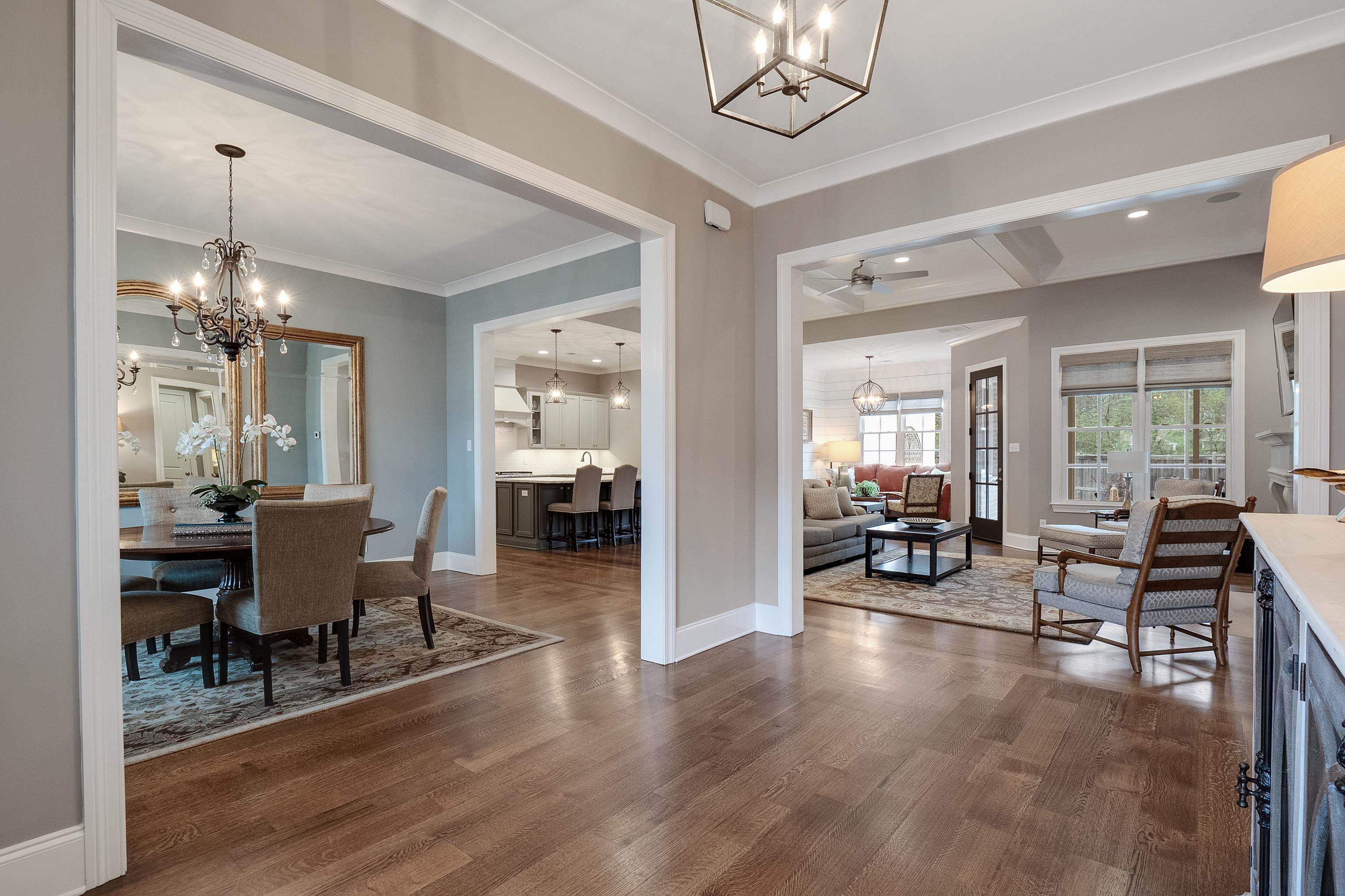 47 Addiegreen Cove Collierville, TN 38017 - Photo 3 of 34 a dining room with wooden floor a chandelier a wooden table and chairs