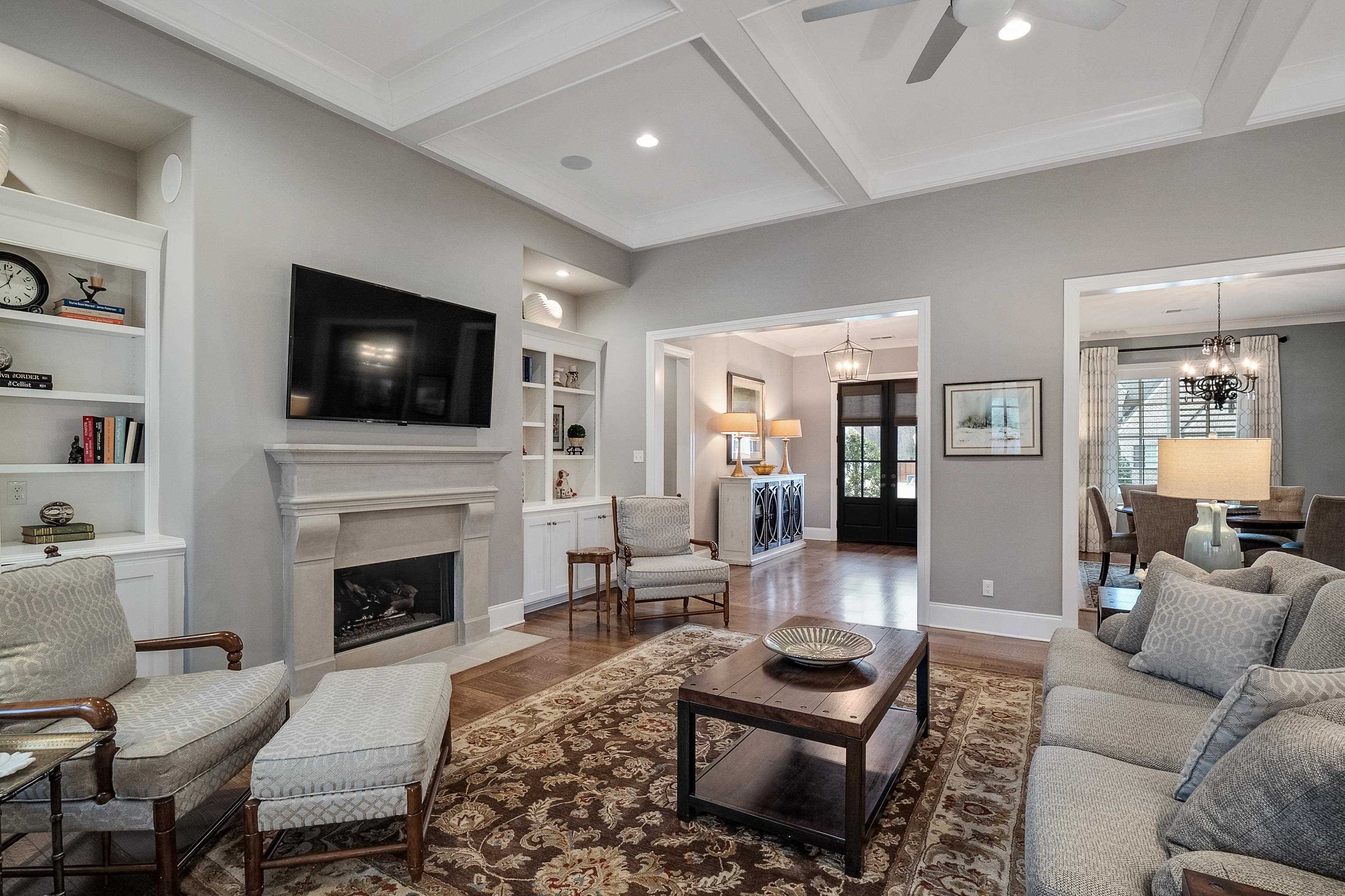 47 Addiegreen Cove Collierville, TN 38017 - Photo 4 of 34 a living room with furniture a flat screen tv and a fireplace