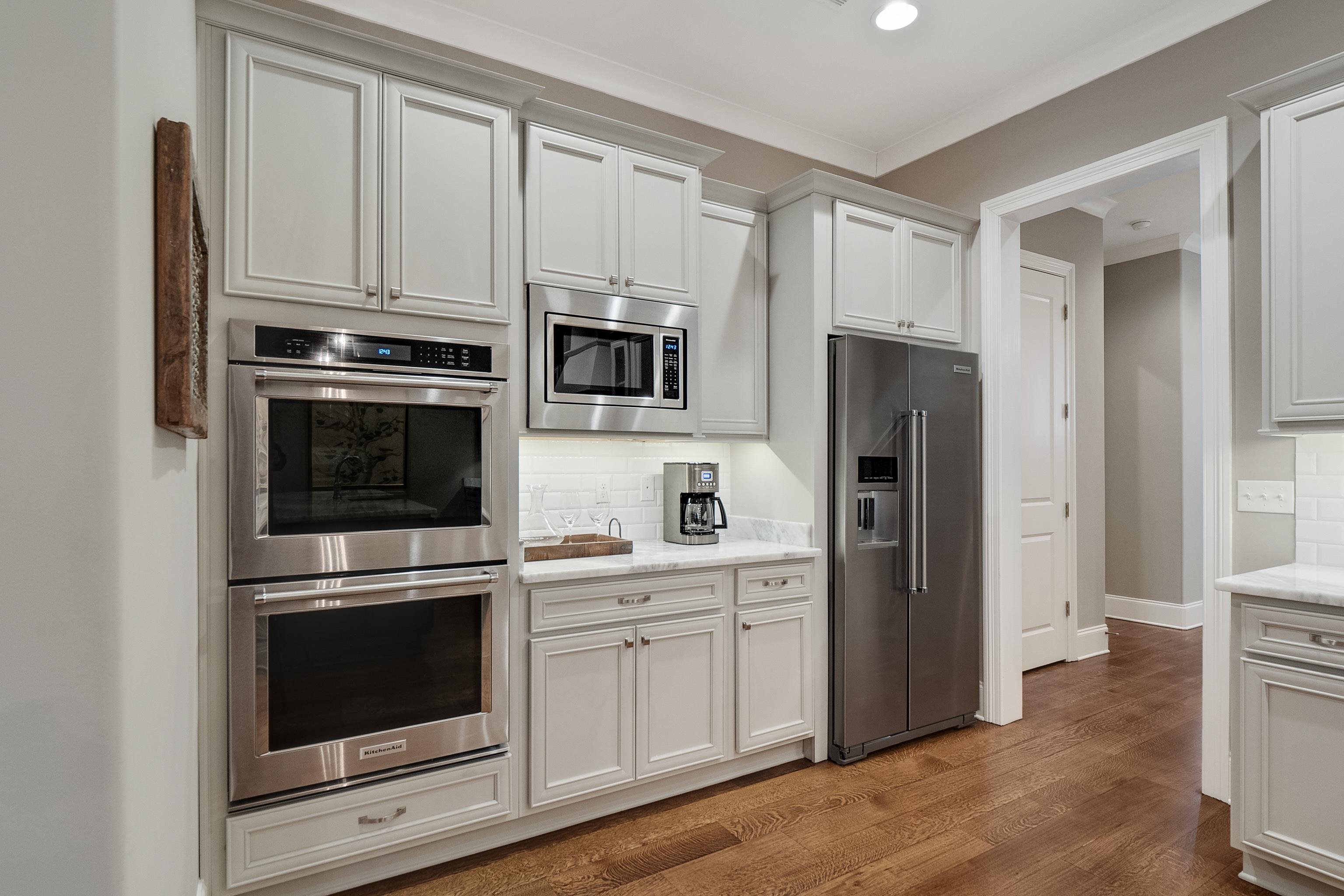 47 Addiegreen Cove Collierville, TN 38017 - Photo 9 of 34 a kitchen with cabinets stainless steel appliances and wooden floor