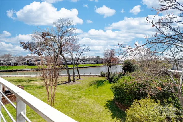 a view of swimming pool with an outdoor seating and a lake view