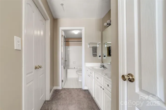 a bathroom with a granite countertop sink mirror and double