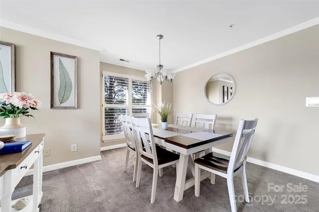 a kitchen with stainless steel appliances kitchen island granite countertop a refrigerator and cabinets
