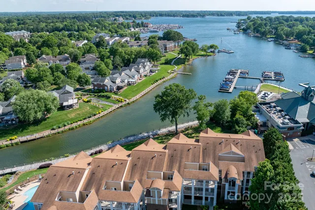 an aerial view of a house with a lake view
