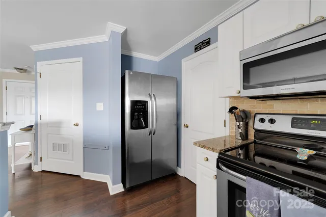 a spacious bedroom with a bed a window and dresser